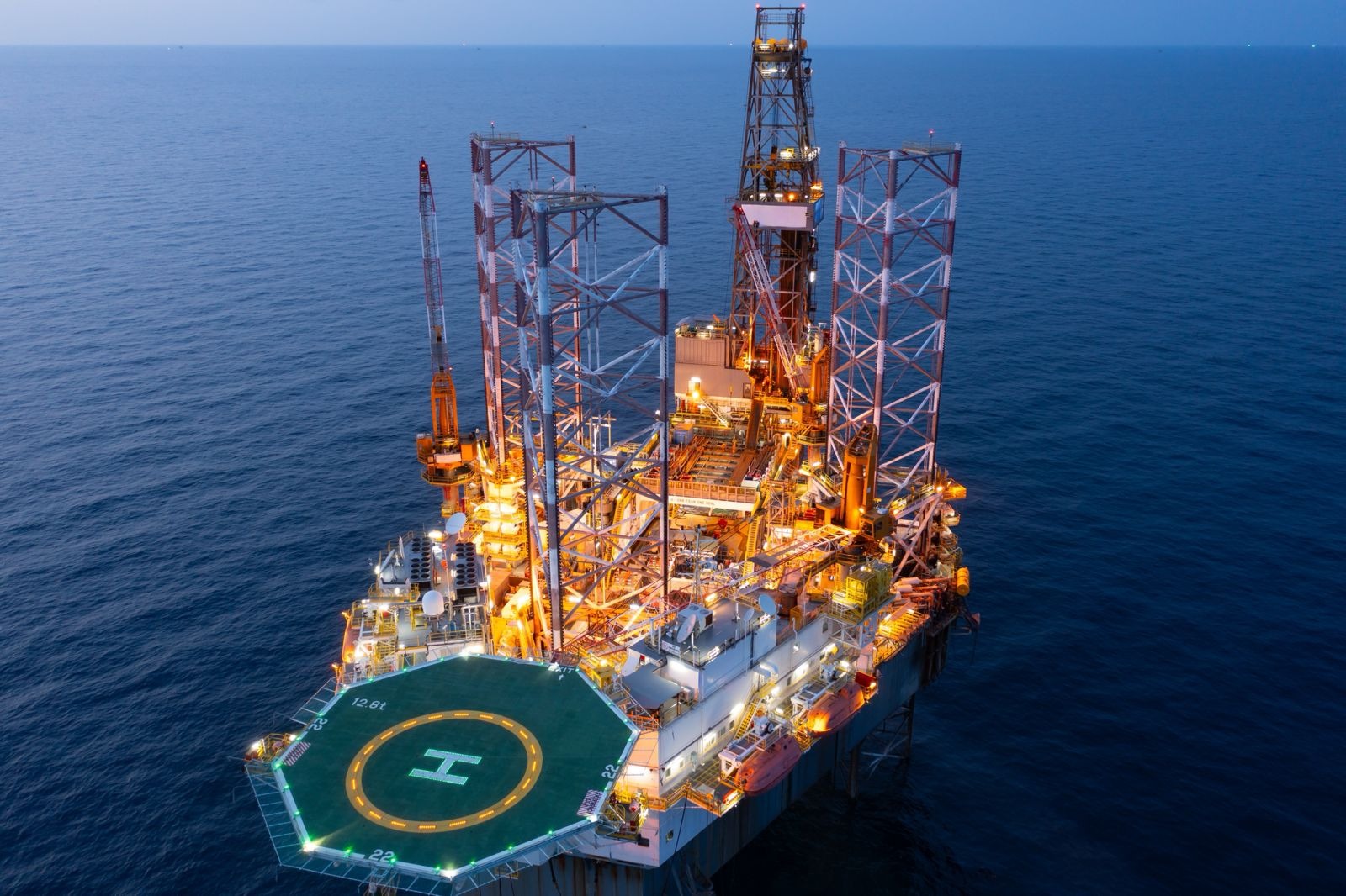 Oil pumpjack operating at sunset